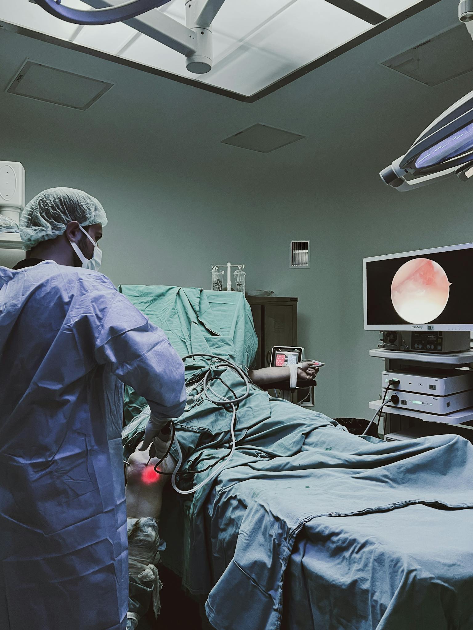 A surgeon performs laparoscopic surgery in a modern operating room, ensuring precision and care.